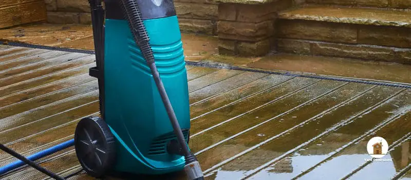 Electric pressure washer on a wooden deck