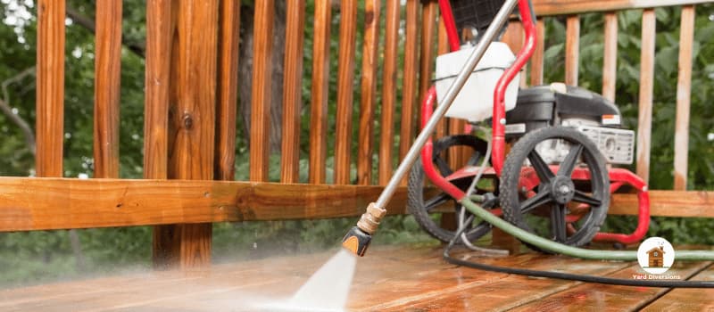 Gas pressure washer cleaning.a deck and patio
