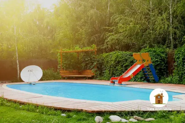 backyard pool with a kids slide and relaxing garden - swimming pool near septic tank