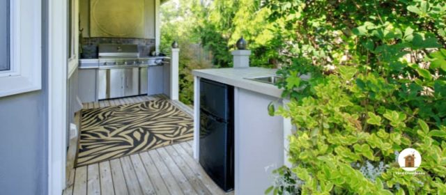 outdoor kitchen area with an outdoor rug on the ground as a pad for walking around