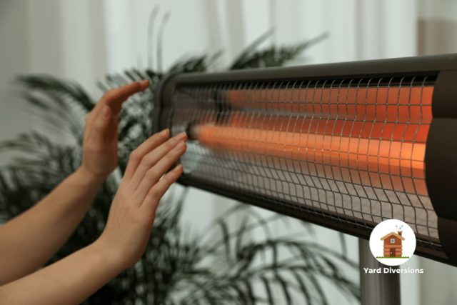 Wide infrared heater to heat a large space with womans hands being heated