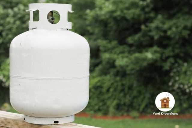 Close up of a propane tank on a patio rail