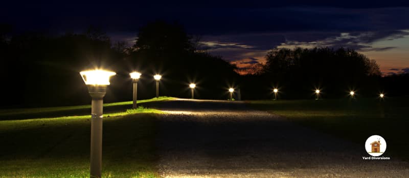Lit up walking path with outdoor lights placed alongside the entire length