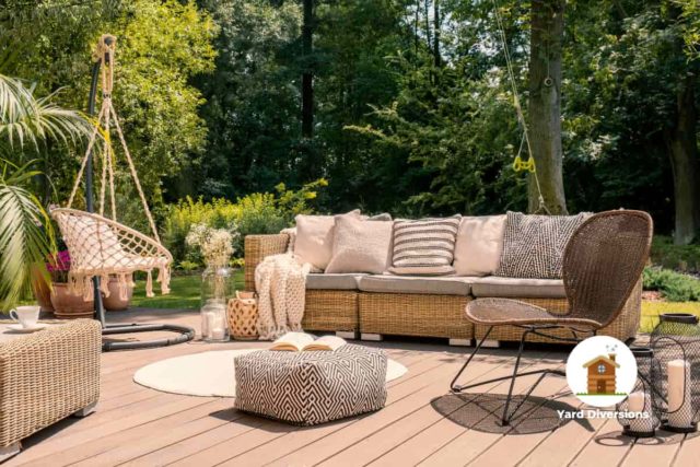 Very nice wicker and cushioned patio furniture on a nice wooden deck