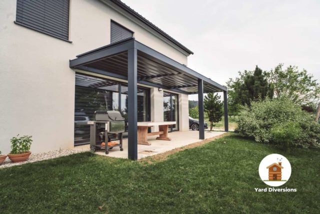 long two section pergola on the side of a house