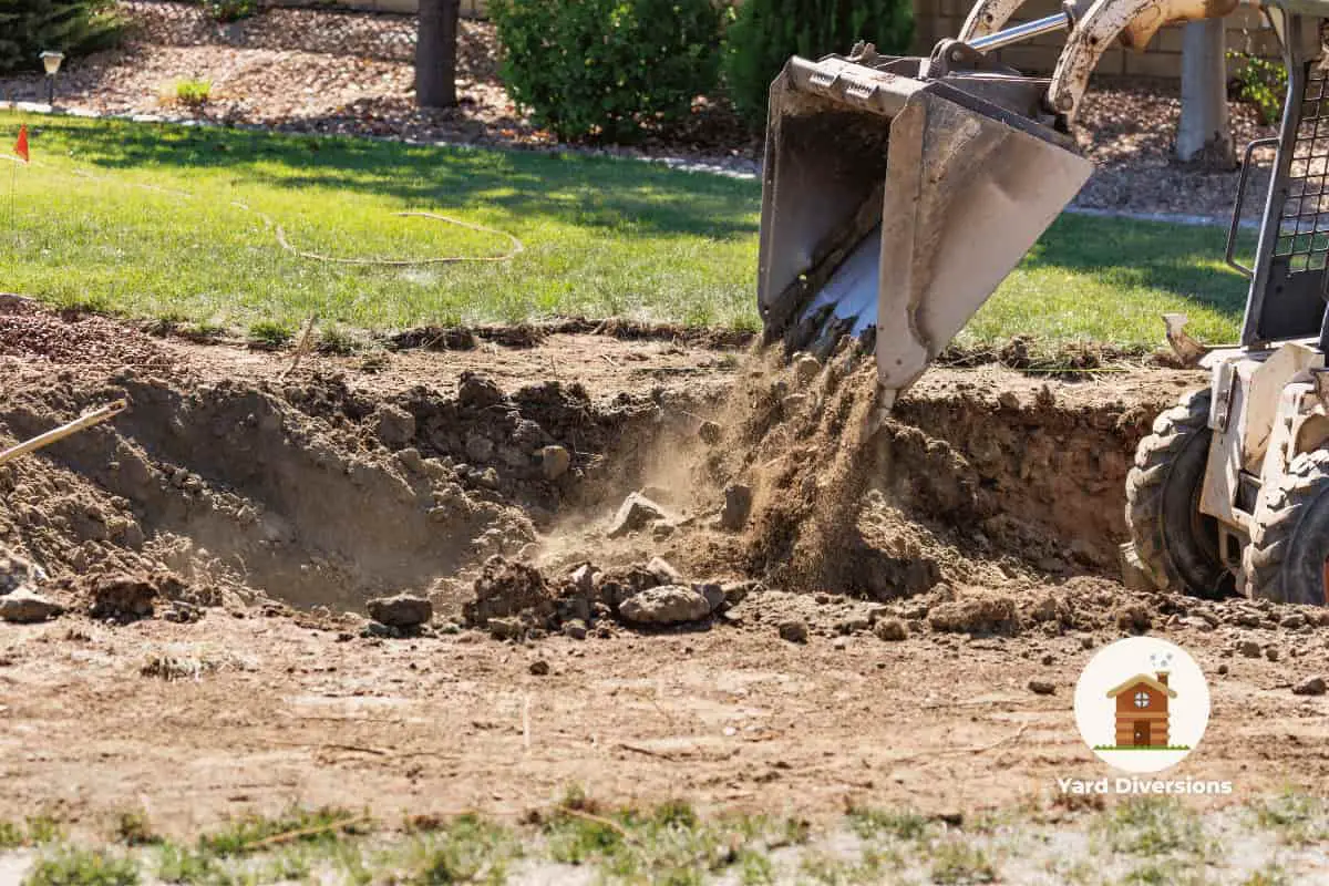 bobcat being used to fill in the hole from removing a pool in the backyard