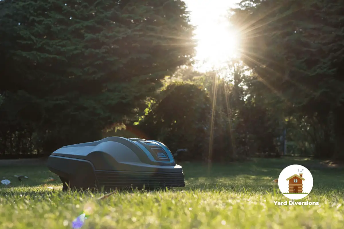 A robotic lawn mower moving and cutting grass with trees in the background