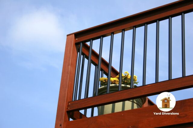 Second floor deck on the house with solid construction and a flower pot in the corner