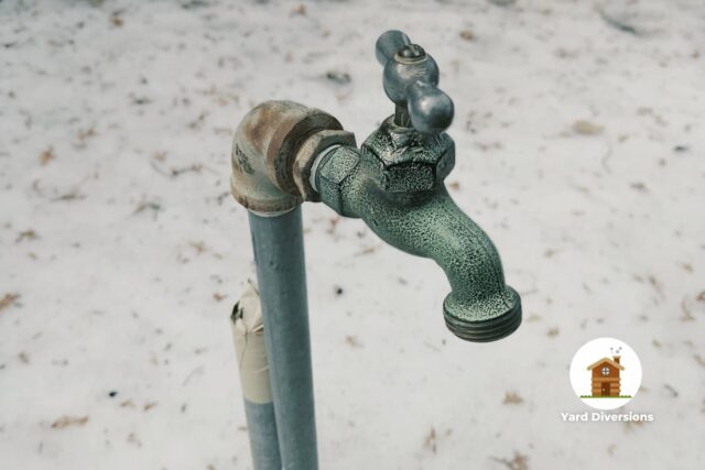 Water spigot outdoor in the snow in winter
