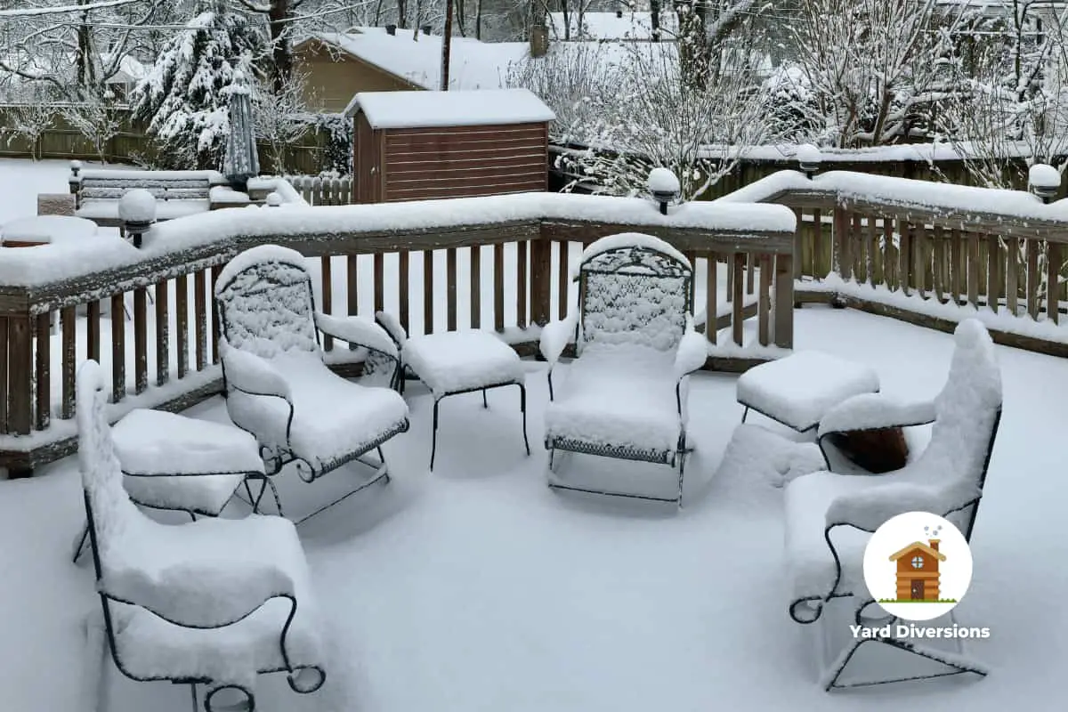 Ill prepared patio furniture on the back deck covered in snow being damaged by winter cold and moisture