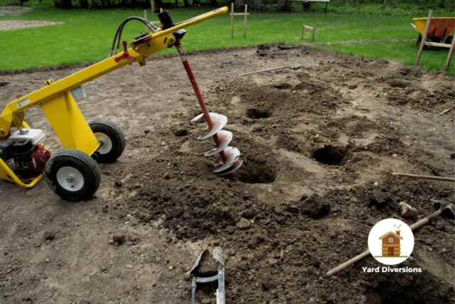 Post hole digger being used to prepare holes in the backyard for a deck install
