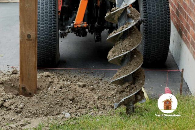 Big machine digger being used to dig post holes for easier work