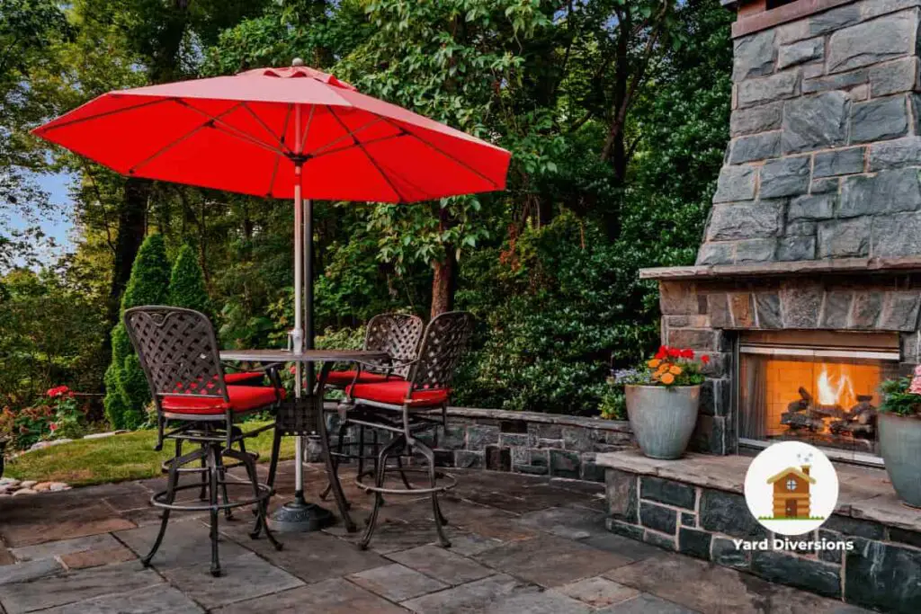well built patio set and table in red with a large patio umbrella covering the table and seating area.