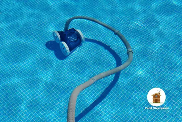 Robot pool cleaner running in the pool to clean up debris like leaves