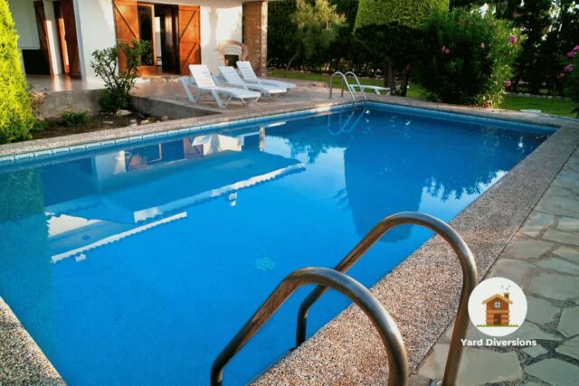 Amazing in ground pool in the backyard of a house with nice space to lounge