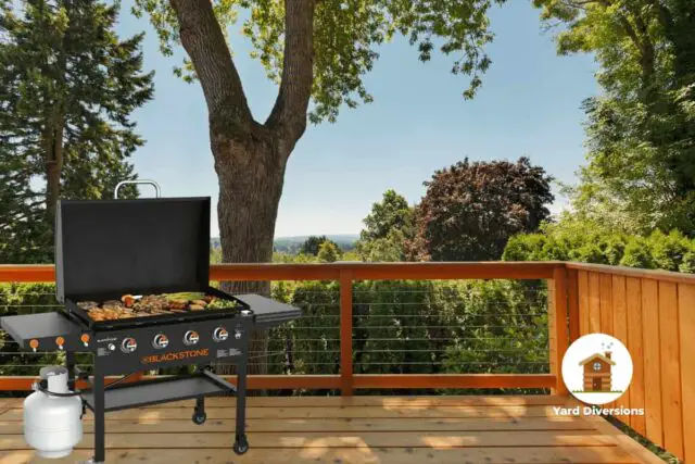 A Blackstone Griddle on a wooden deck in the backyard