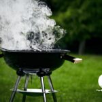 Smoke coming off a charcoal grill in the backyard