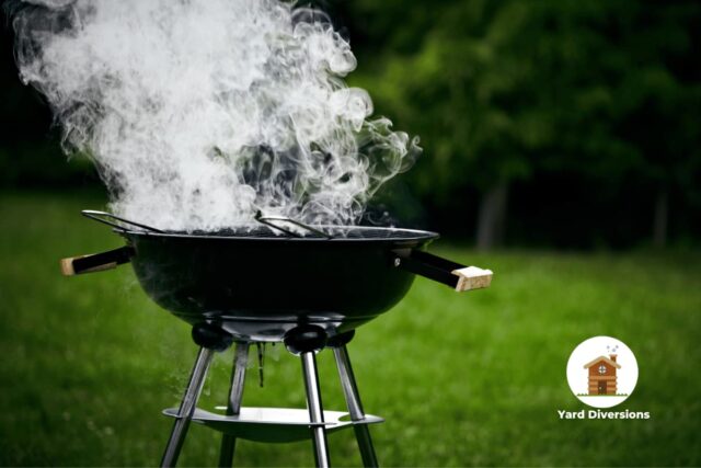 Smoke coming off a charcoal grill in the backyard