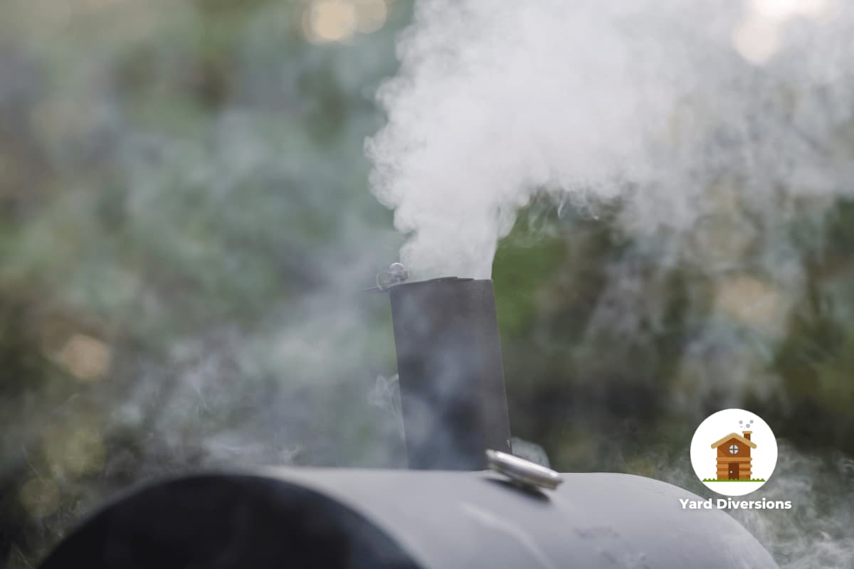 Smoke pouring out from a bbq smoker setup