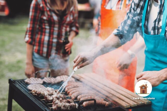 People standing around a backyard barbeque grill getting ready to eat food