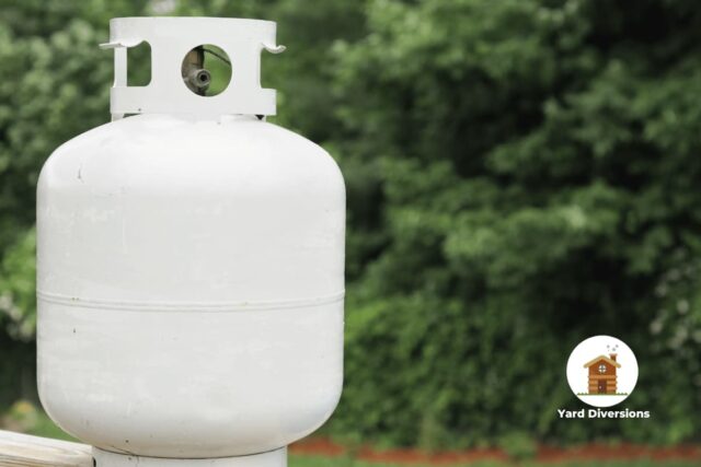 Propane tank on the deck waiting to be connected to a propane grill