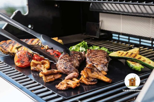 Food being grilled on a grill mat on top of a running barbeque