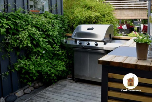 A nice gass grill on a wood deck outside