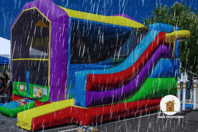 bounce house on concrete ground with rain falling