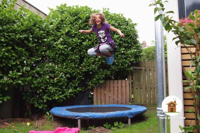 Kid enjoying a trampoline in the backyard