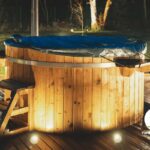 Hot tub lit up in the backyard at night