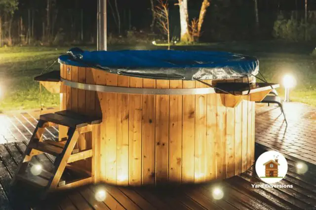 Hot tub lit up in the backyard at night