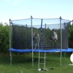 Kids bouncing on a backyard trampoline having fun