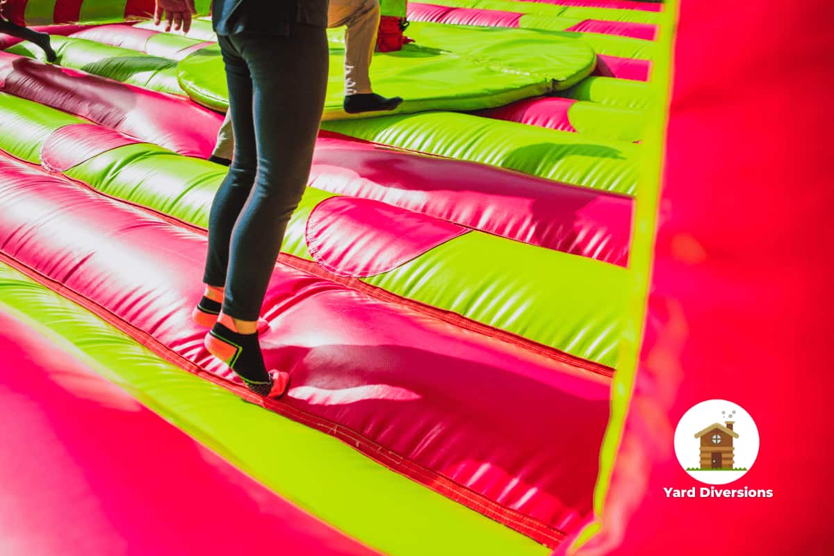 View of the floor of a bouncy house with people jumping on it