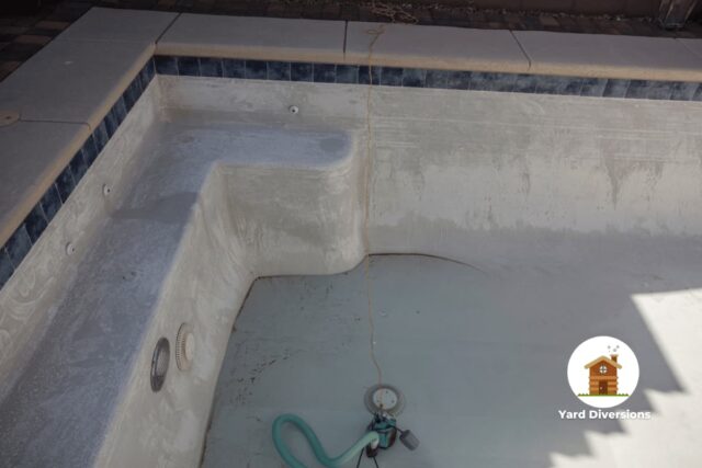 Empty pool being cleaned and prepared to fill