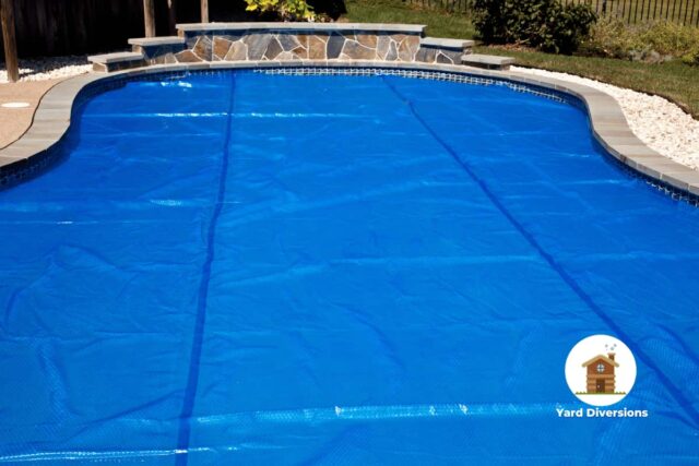 Pool cover liner laying on top of the pool to protect it