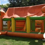Bounce house inflating in the backyard to allow kids to play
