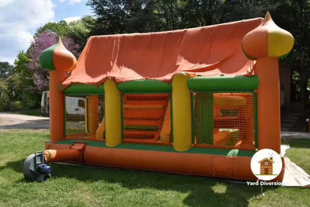 Bounce house inflating in the backyard to allow kids to play