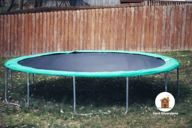 Aged and well used trampoline in a backyard