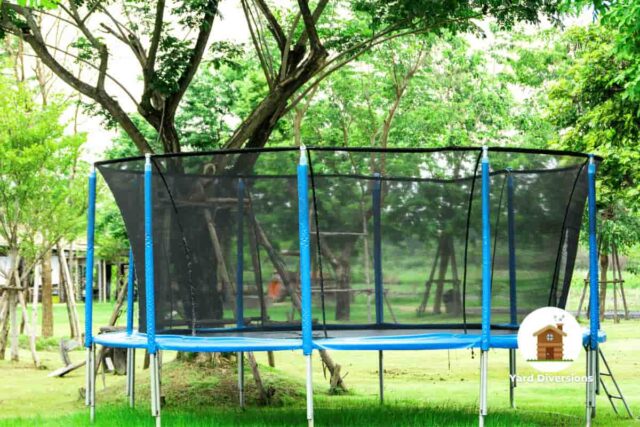 An empty trampoline in a backyard ready to be used