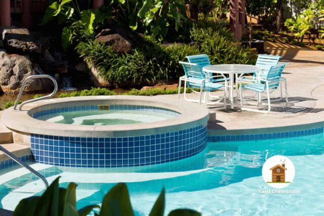 Pool with an attached hot tub with a nice lounge area with patio furniture to sit in and eat at the table