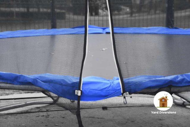 Trampoline opened up to get in placed on concrete