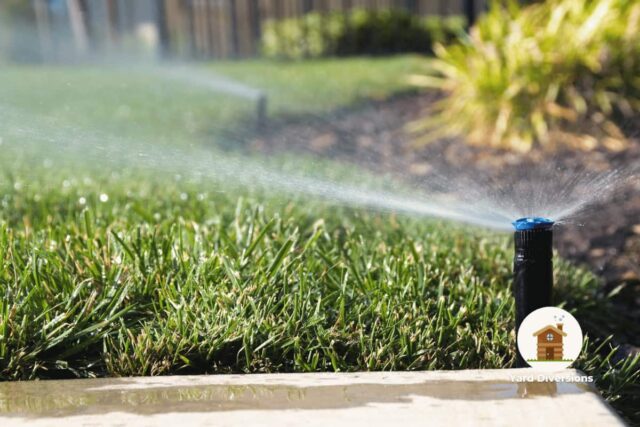 Sprinkler at the edge of the grass spraying out into the main lawn without wasting water on the concrete