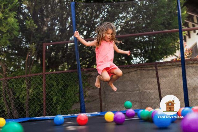 Kid jumping and having a fun play session on a trampoline with ball pit balls