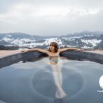 Woman relaxing in the most fabulous hot tub location in the mountains