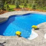 High-quality backyard pool iwith a easy entry and well landscaped yard