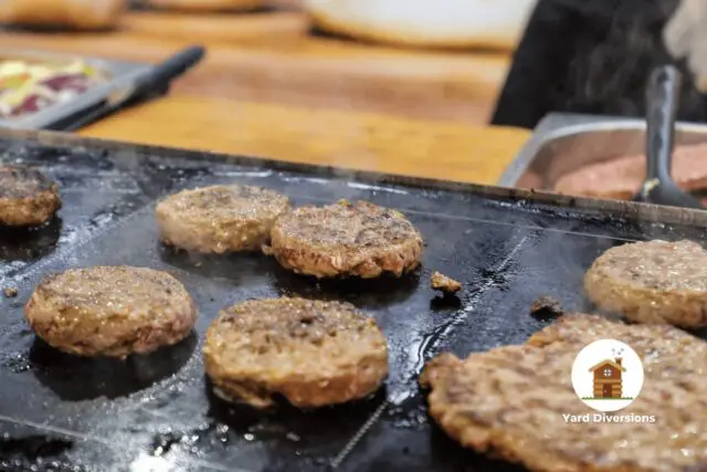 Cooking hamburgers on a outdoor griddle