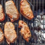 Pork chops cooking over indrect heat