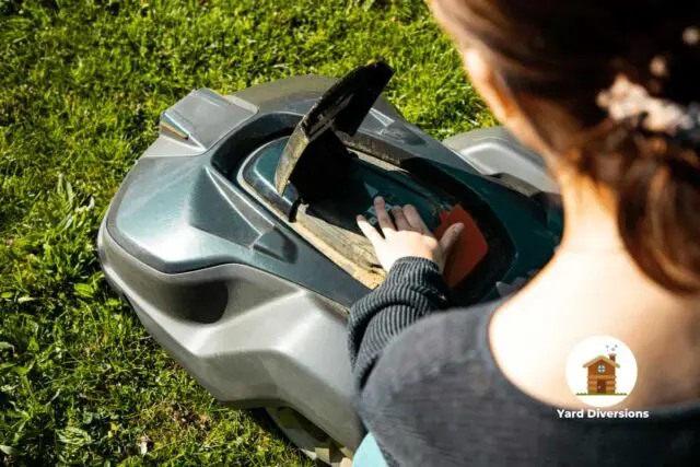 Woman checking her automatic lawn mower