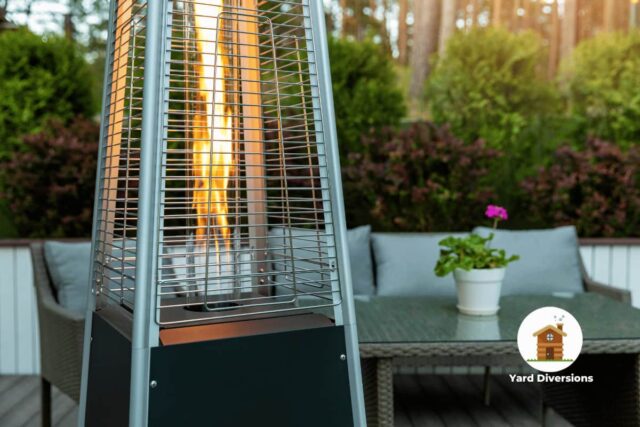 Patio heater running on a nice deck near patio furniture to provide heat at night