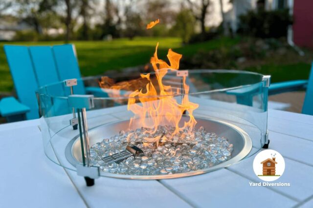 Close up of a in table glass fire pit on a deck